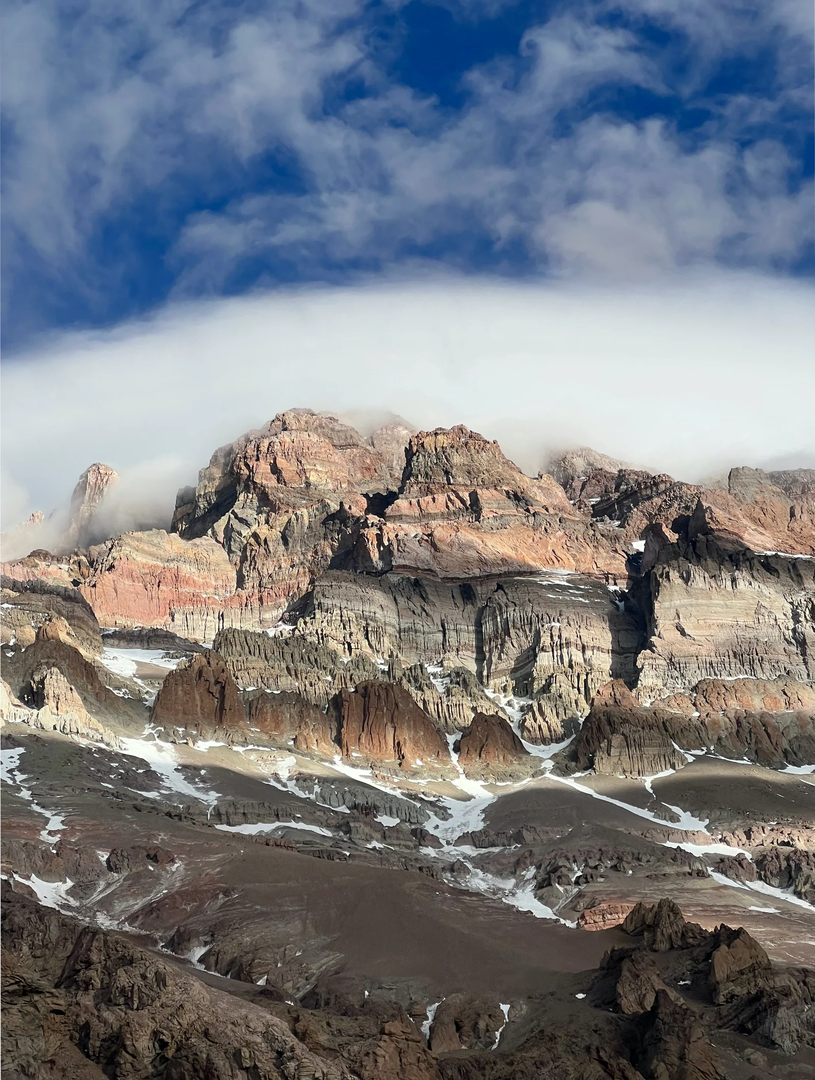 Glowing tent at dusk with mountain silhouettes — base camp night scene