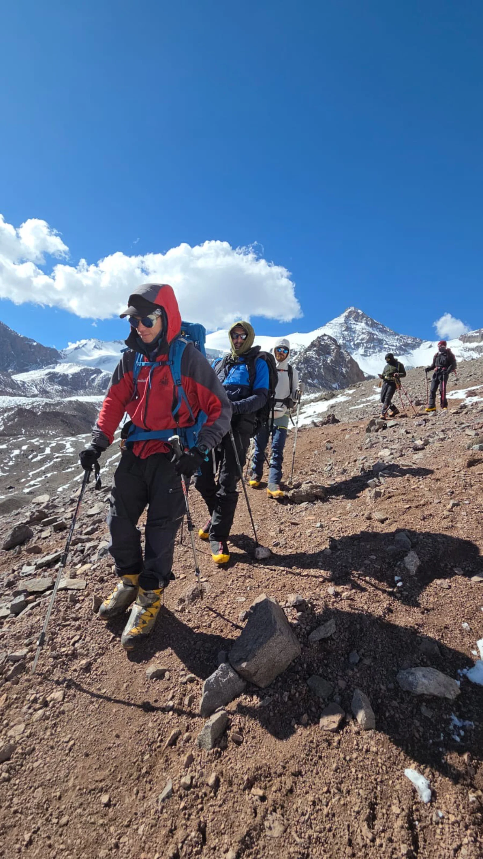 Guided expedition team on rocky high-altitude terrain