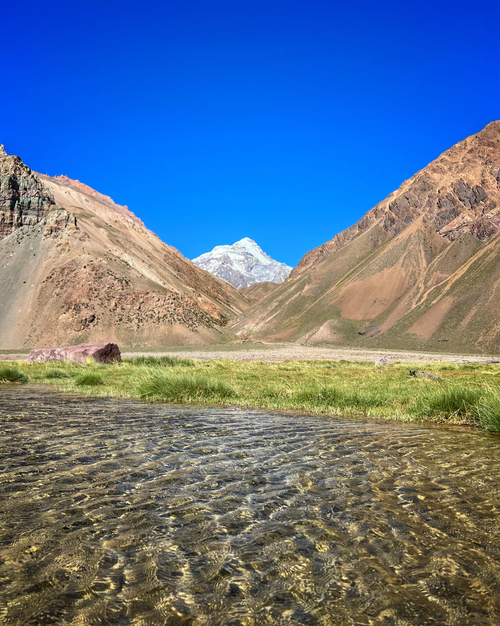 Crystal clear river with Aconcagua in the background — the start of the approach